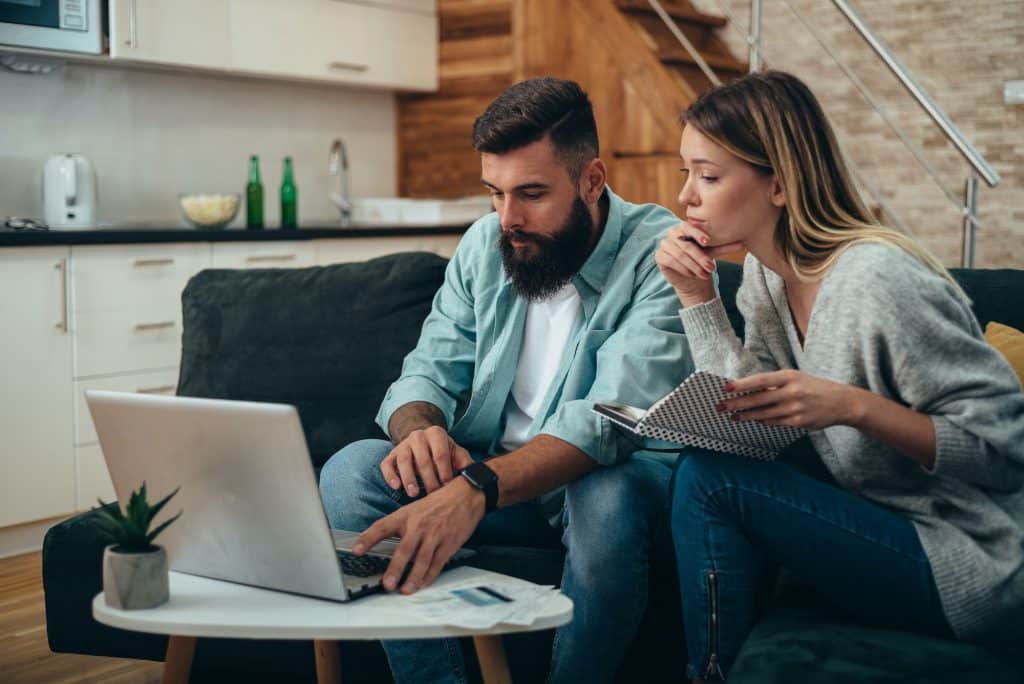 Young beautiful couple using a laptop