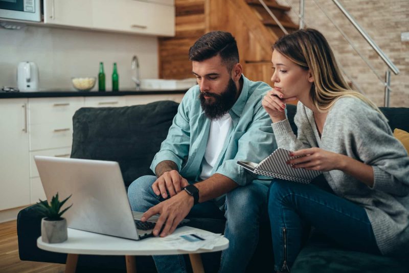 Young beautiful couple using a laptop