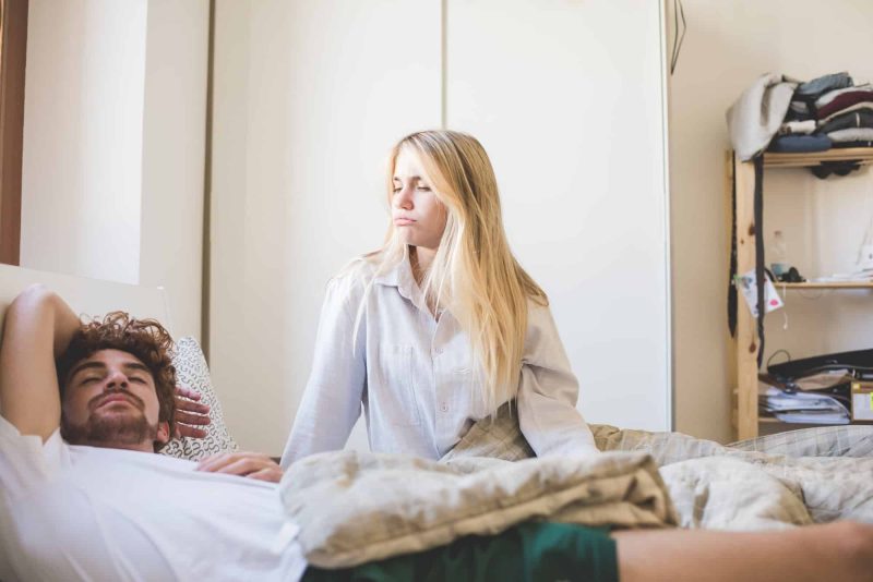 young couple indoor bedroom arguing